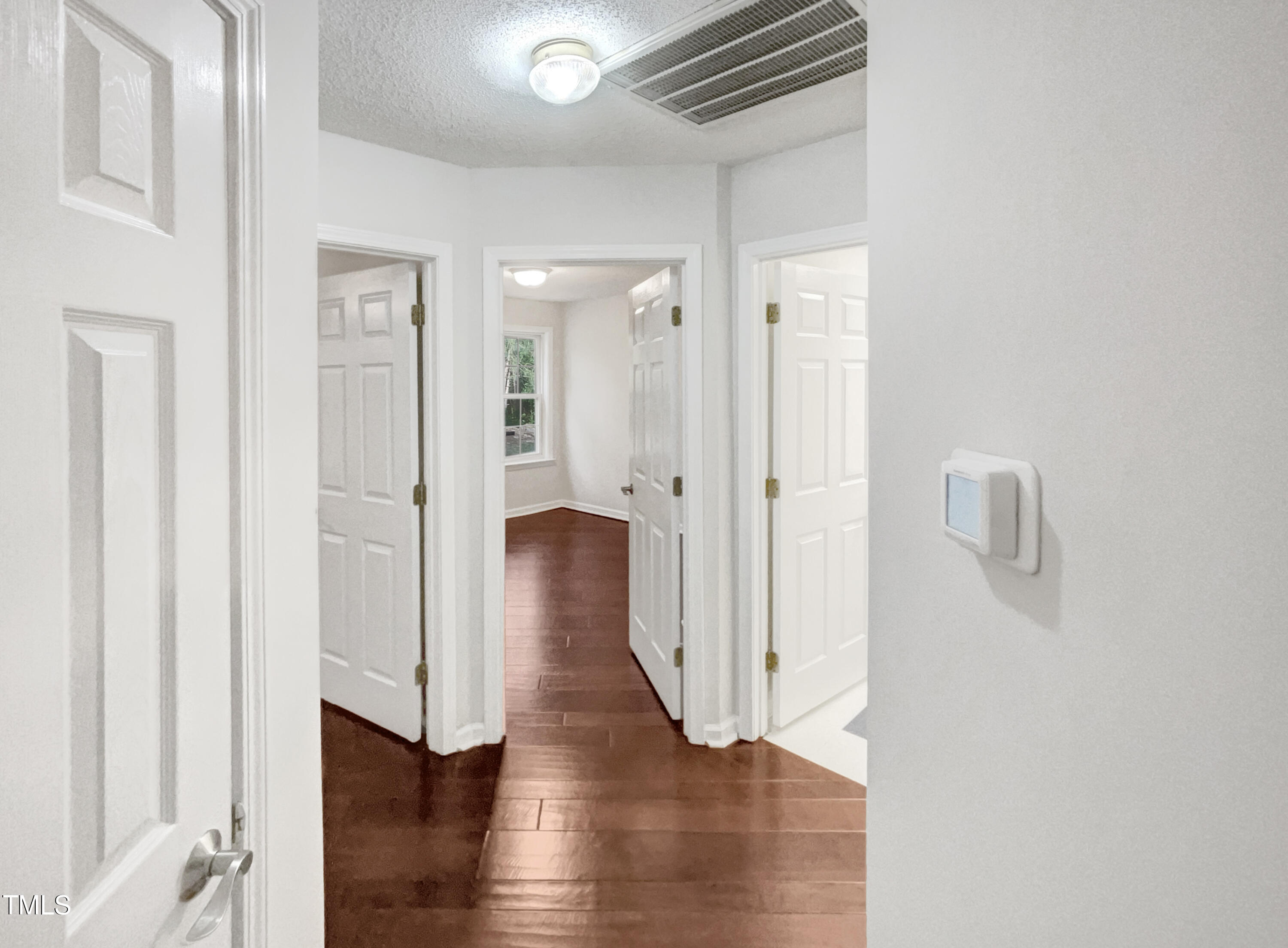 11 Windsor Glen Drive Durham, NC 27703 - Photo 24 of 29 a view of an empty room with wooden floor and a bathroom