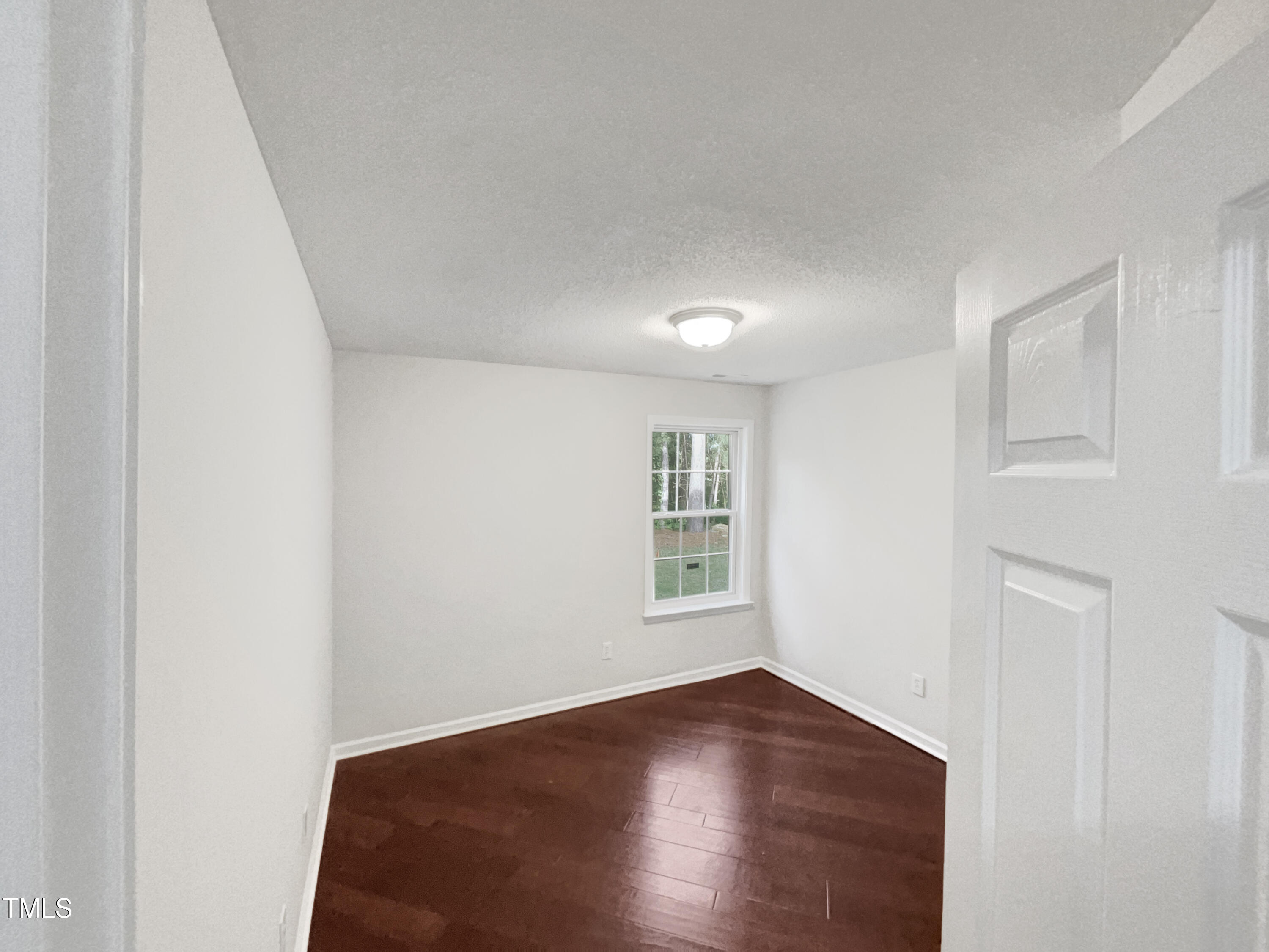 11 Windsor Glen Drive Durham, NC 27703 - Photo 26 of 29 an empty room with wooden floor and windows
