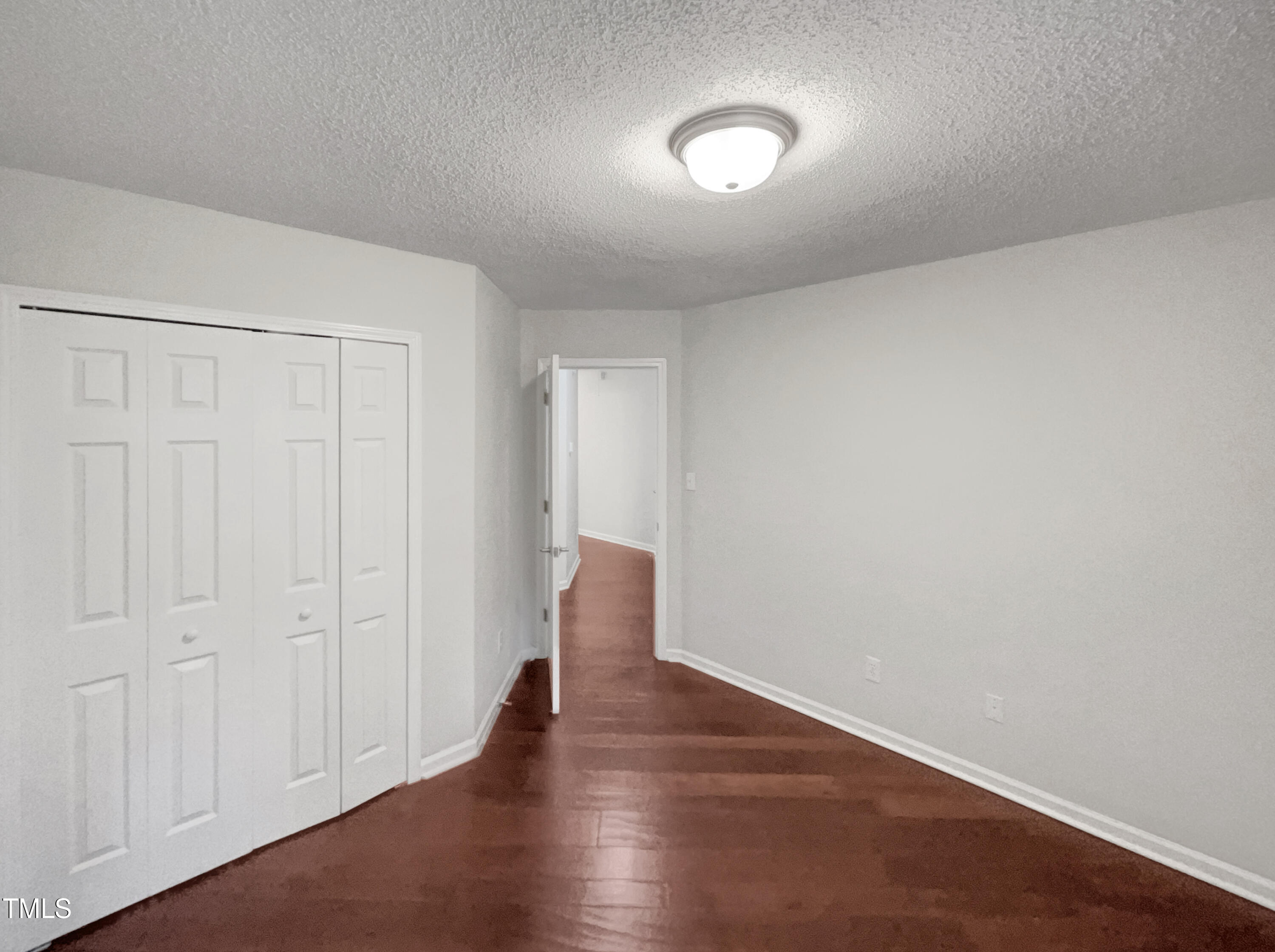 11 Windsor Glen Drive Durham, NC 27703 - Photo 27 of 29 a view of an empty room with wooden floor