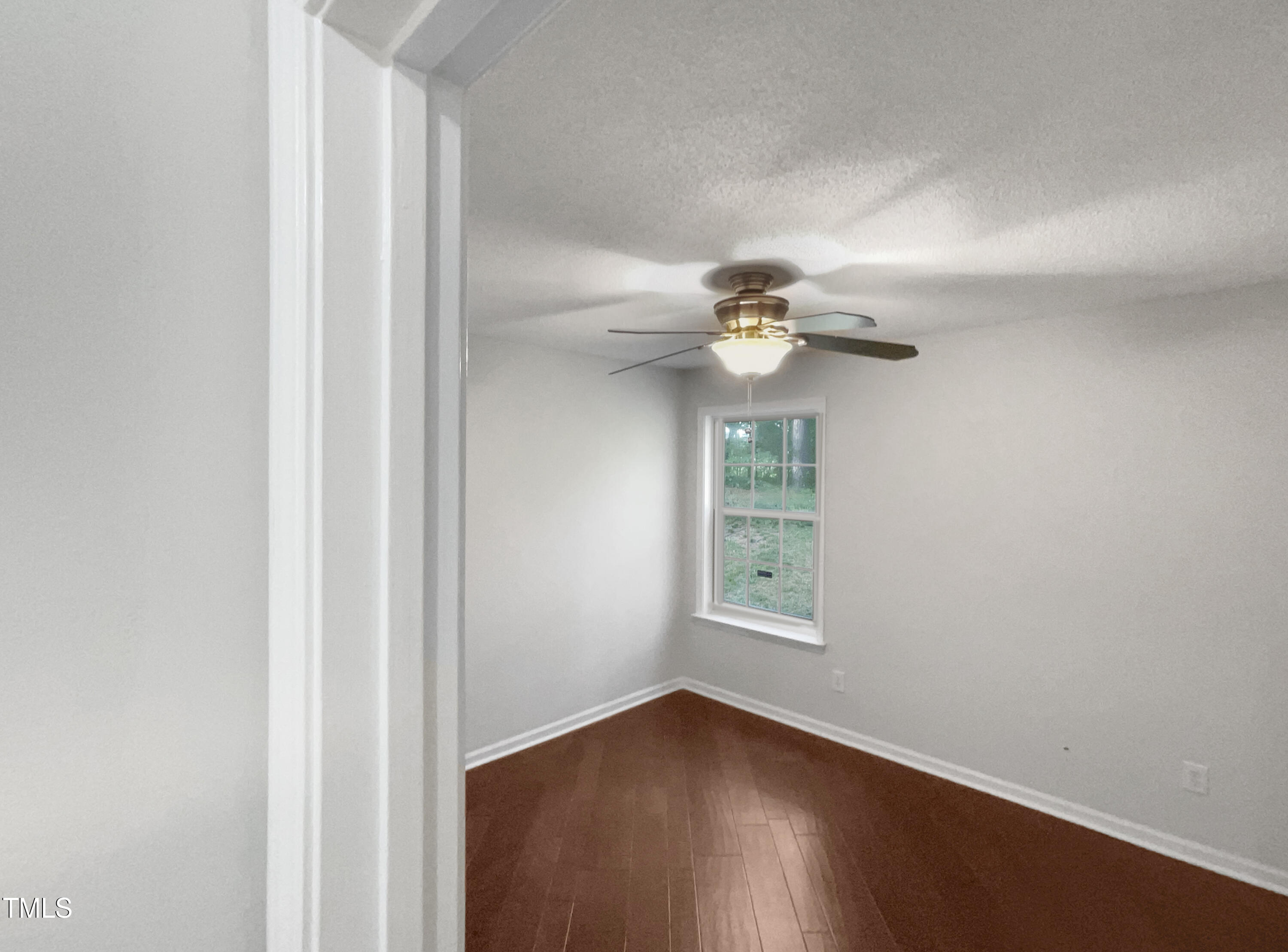 11 Windsor Glen Drive Durham, NC 27703 - Photo 28 of 29 an empty room with wooden floor fan and windows