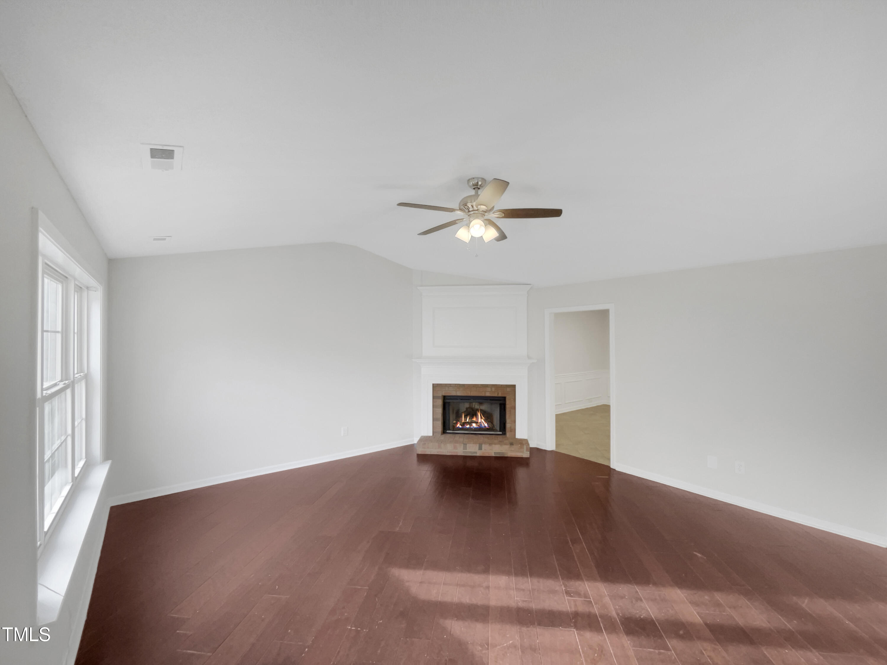 11 Windsor Glen Drive Durham, NC 27703 - Photo 3 of 29 a view of empty room with a window and a ceiling fan