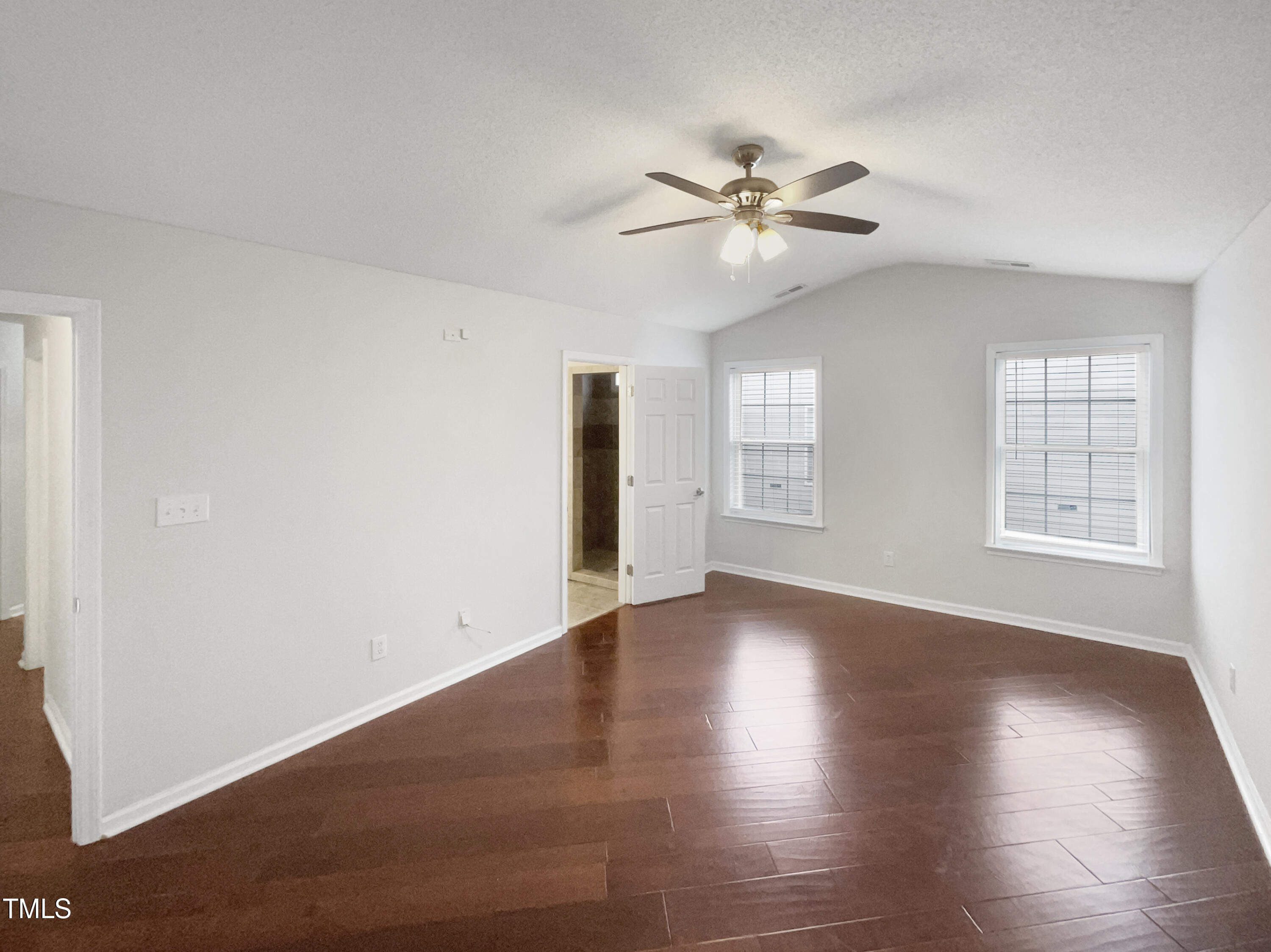 11 Windsor Glen Drive Durham, NC 27703 - Photo 5 of 29 a view of an empty room with wooden floor and a window