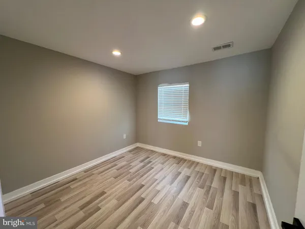 a view of room with window and wooden floor