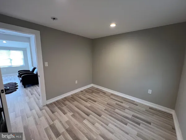 a view of a livingroom with wooden floor and a flat screen tv