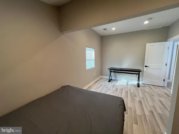 a view of a bedroom with a bed and a window