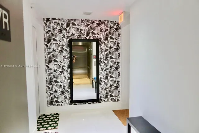 a living room with furniture a table and a large window