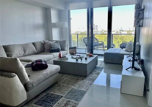 a living room with furniture and a gym machine