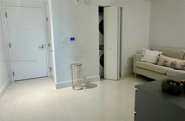 a large bed sitting in a bedroom next to a window