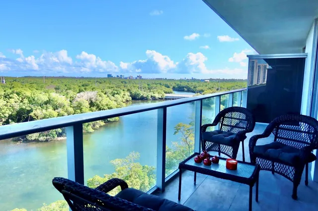 a view of a chairs and table in the balcony
