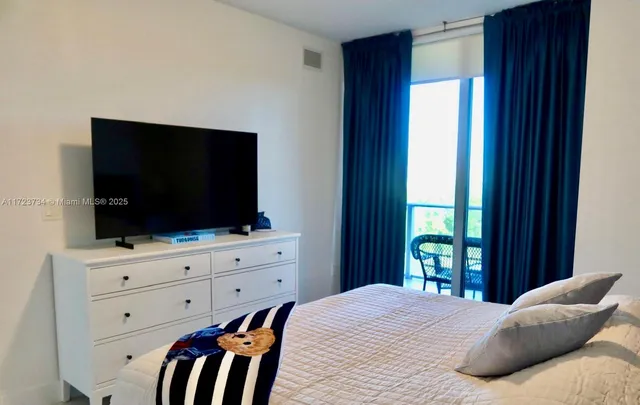 a view of a building with sitting area and garden