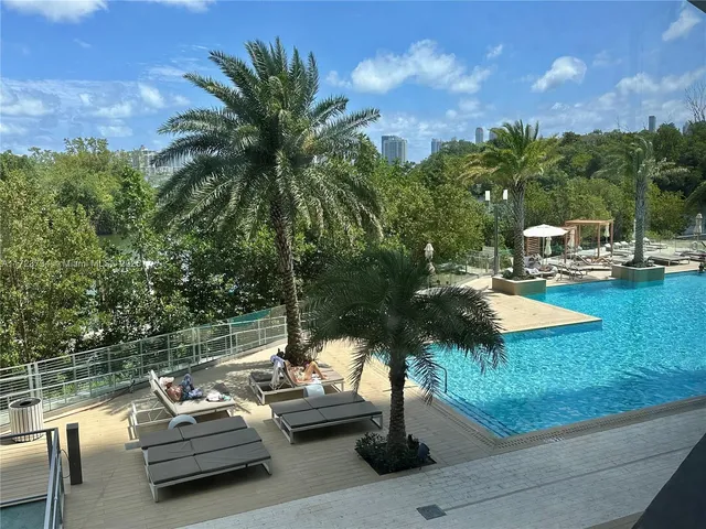 a backyard of a house with lots of green space and bench