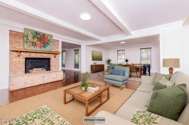a view of empty room with wooden floor and fireplace