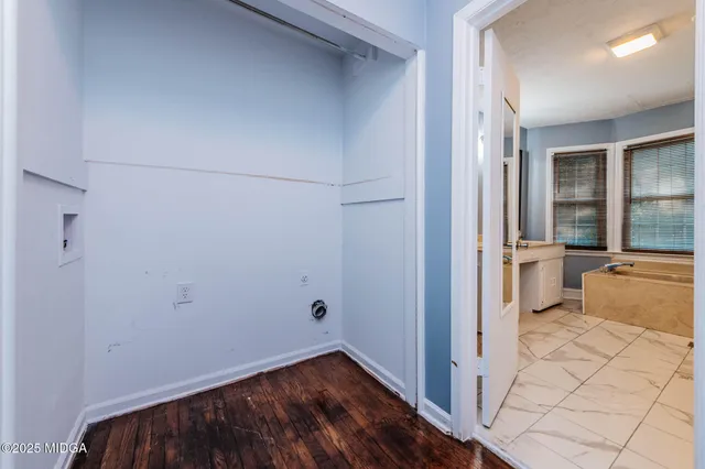 a bathroom with a double vanity sink mirror and bathtub