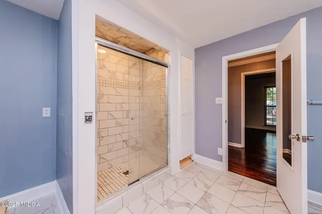 an empty room with a chandelier fan and ceiling fan
