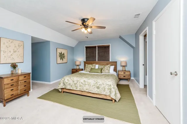 an empty room with closet and a chandelier fan