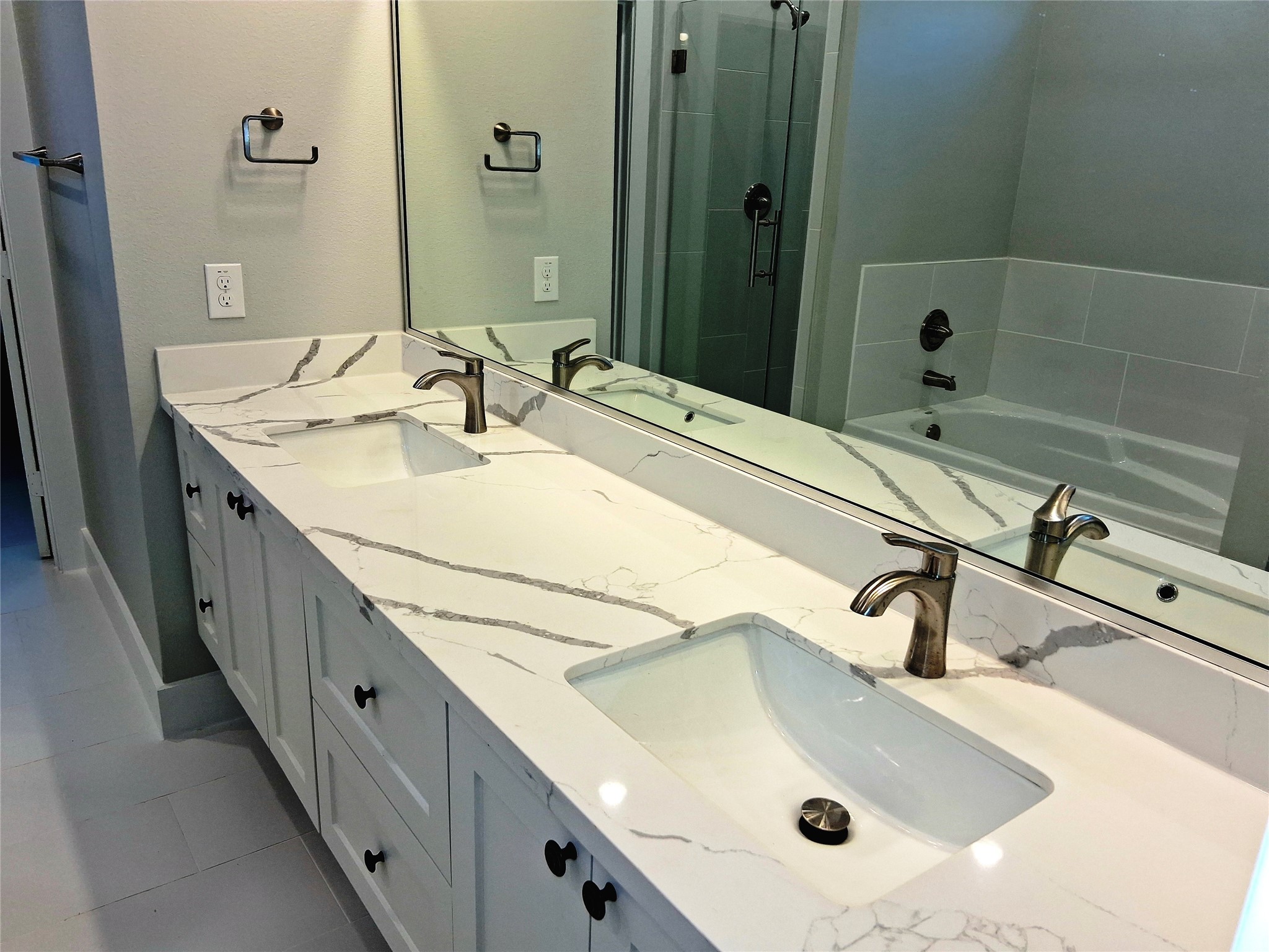 9001 Cheer Street Houston, TX 77063 - Photo 13 of 29 a bathroom with a double vanity sink and a tub