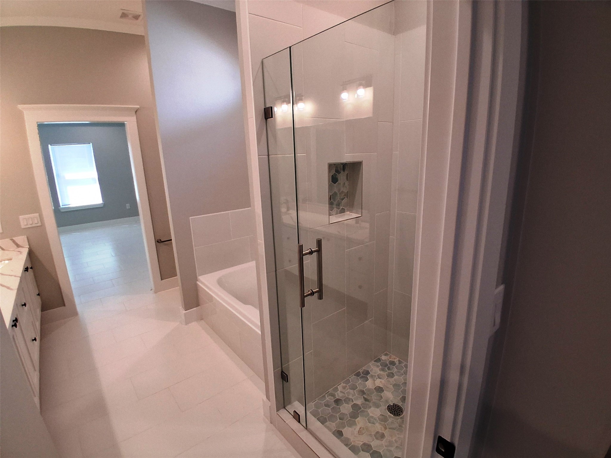 9001 Cheer Street Houston, TX 77063 - Photo 17 of 29 a bathroom with a glass shower door