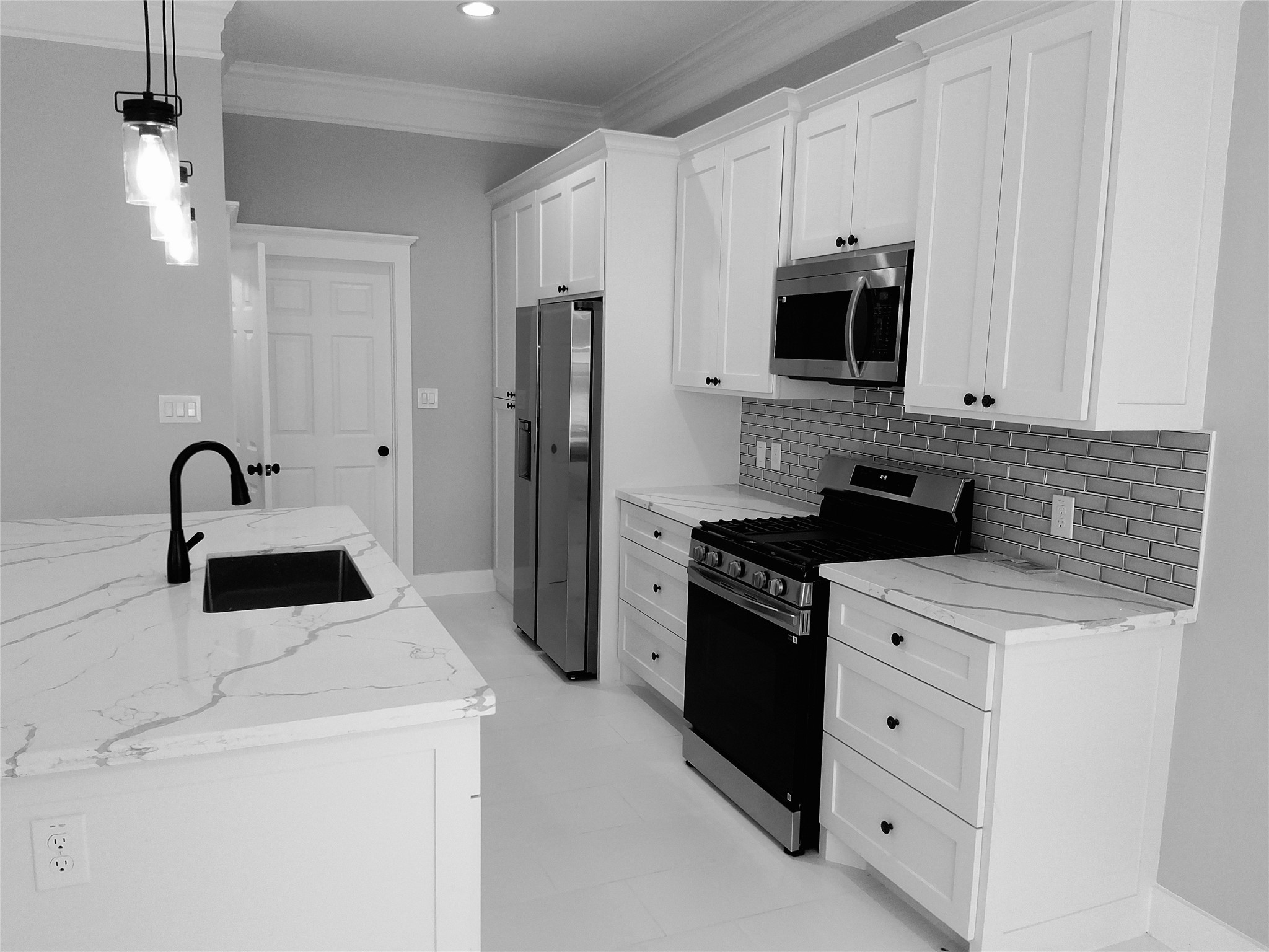 9001 Cheer Street Houston, TX 77063 - Photo 5 of 29 a kitchen with stainless steel appliances a stove microwave and refrigerator