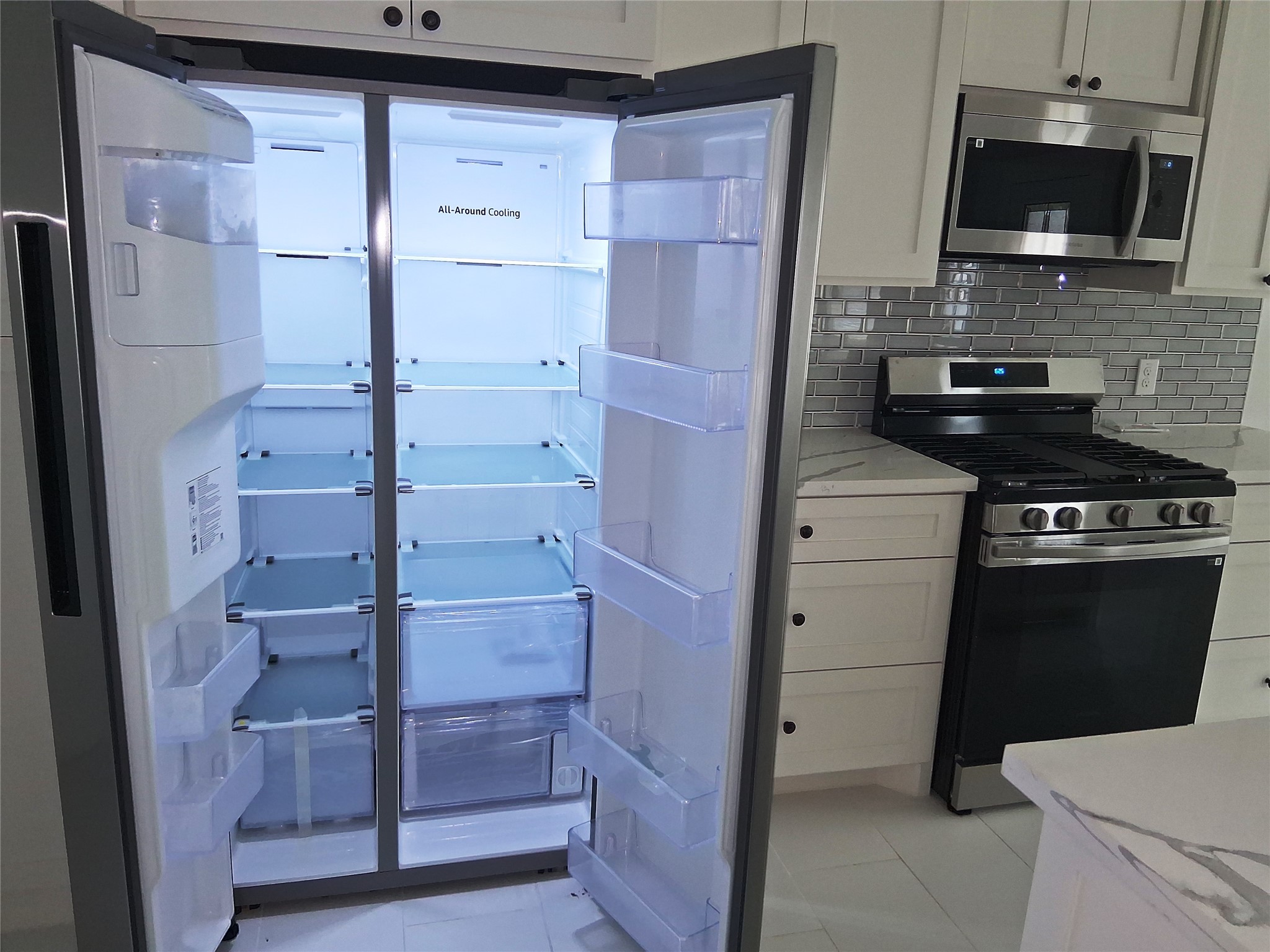 9001 Cheer Street Houston, TX 77063 - Photo 9 of 29 a kitchen with a refrigerator stove and a sink