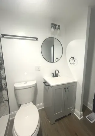 a bathroom with a toilet and a shower