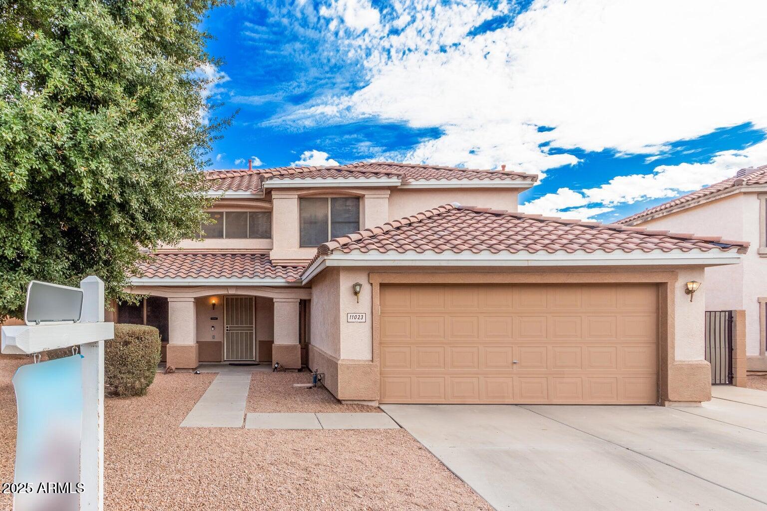a front view of a house with a garage