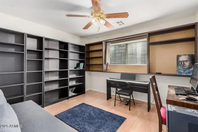 a view of a workspace with furniture and a window