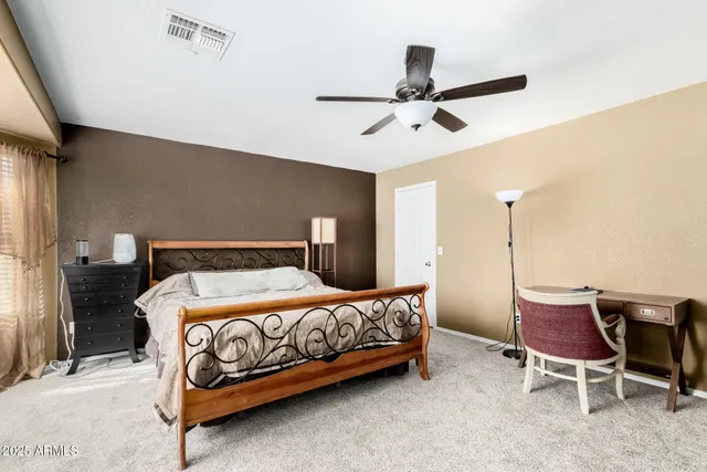 a bedroom with a bed and a chair