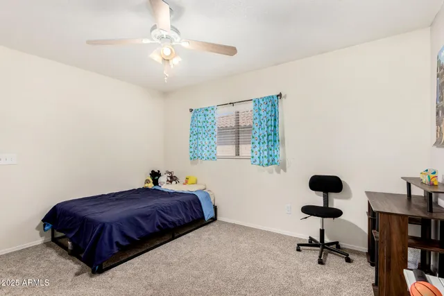 a bedroom with a bed dresser and a window