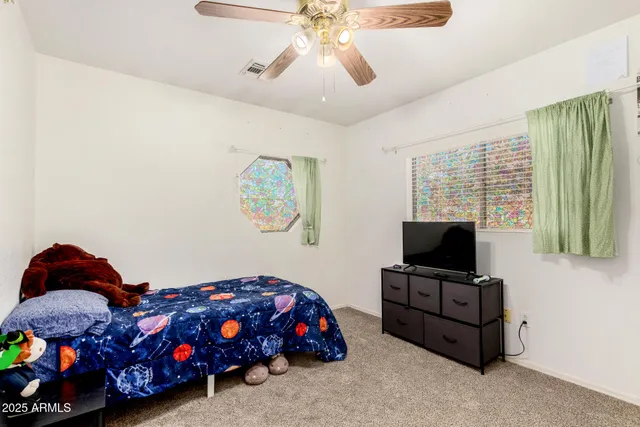 a bedroom with a bed and a window