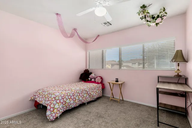 a bedroom with a bed and a table