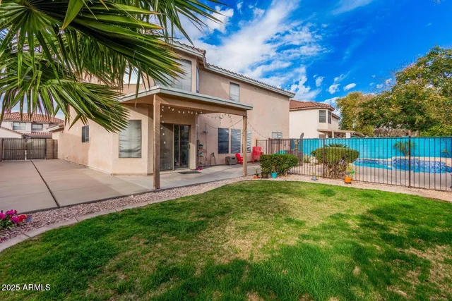 a view of a backyard with a garden and entertaining space