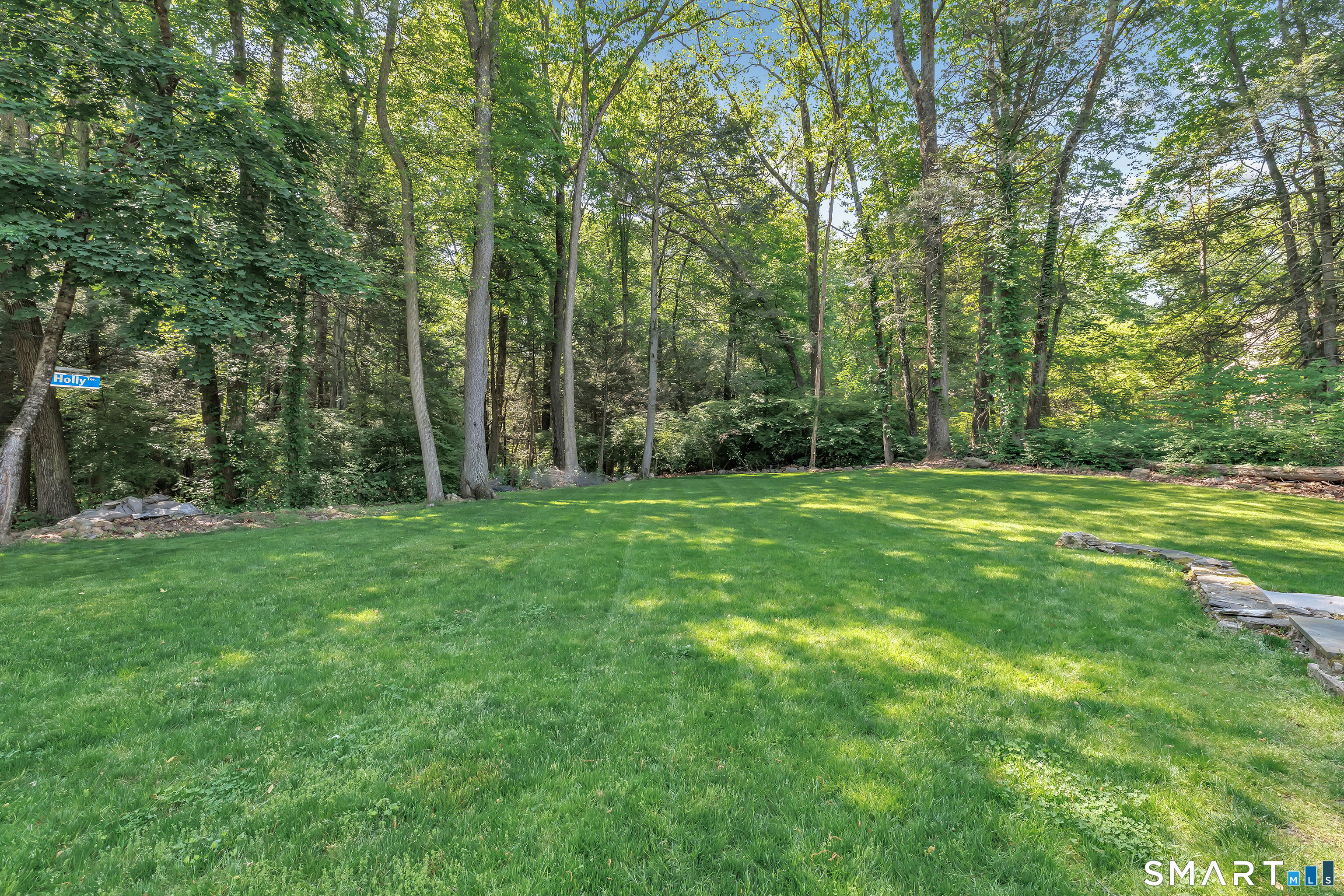 57 Olmstead Road Redding, CT 06896 - Photo 22 of 22 a view of a grassy field with trees in the background