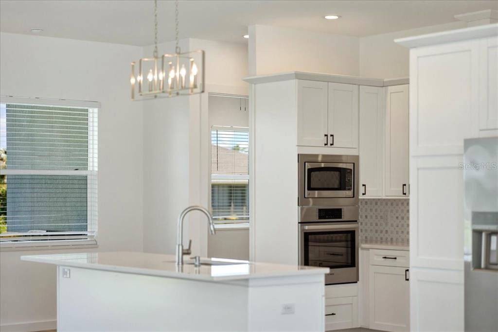1215 Rio De Janeiro Avenue Punta Gorda, FL 33983 - Photo 28 of 65 a kitchen with stainless steel appliances granite countertop a refrigerator and a sink
