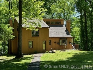 202 Crane Hollow Road Bethlehem, CT 06751 - Photo 18 of 36 a front view of a house with a yard