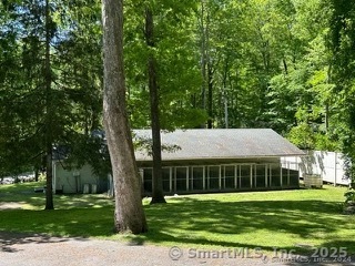 202 Crane Hollow Road Bethlehem, CT 06751 - Photo 4 of 36 a front view of a house with a yard
