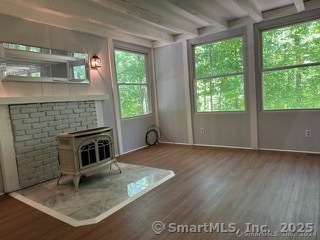 202 Crane Hollow Road Bethlehem, CT 06751 - Photo 5 of 36 an empty room with floor to ceiling window and an outdoor view