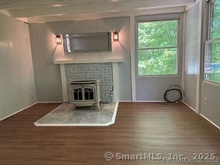 202 Crane Hollow Road Bethlehem, CT 06751 - Photo 6 of 36 a view of empty room with wooden floor and fireplace
