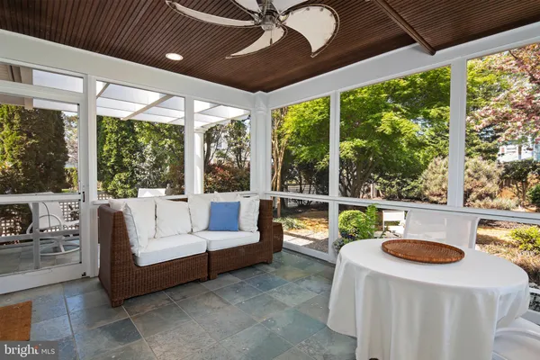 a kitchen with stainless steel appliances granite countertop a stove a sink a dining table and chairs