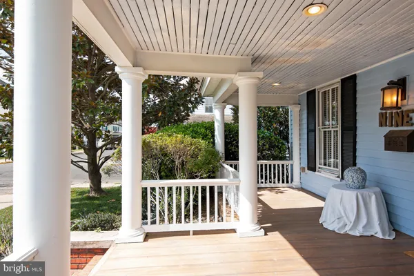 a view of a patio with a table chairs and a porch