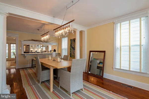 a view of a livingroom with wooden floor and windows