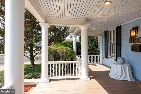 a view of a patio with a table chairs and a porch