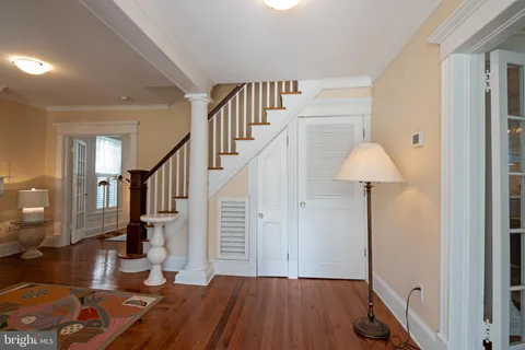 a view of entryway and hall with wooden floor