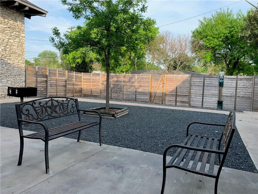 2301 Ohlen Road, Unit 107 Austin, TX 78757 - Photo 7 of 8 Fenced backyard with a patio area