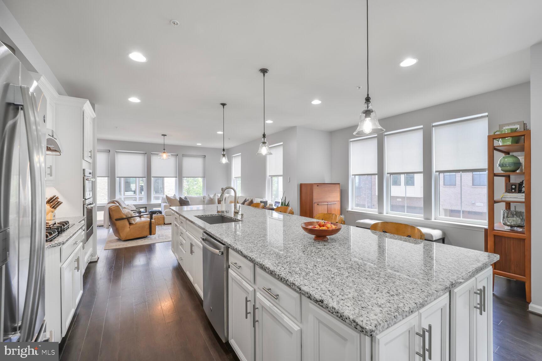 515 Riversail Lane, Unit 430 Oxon Hill, MD 20745 - Photo 11 of 54 a kitchen with counter space appliances and a wooden floor