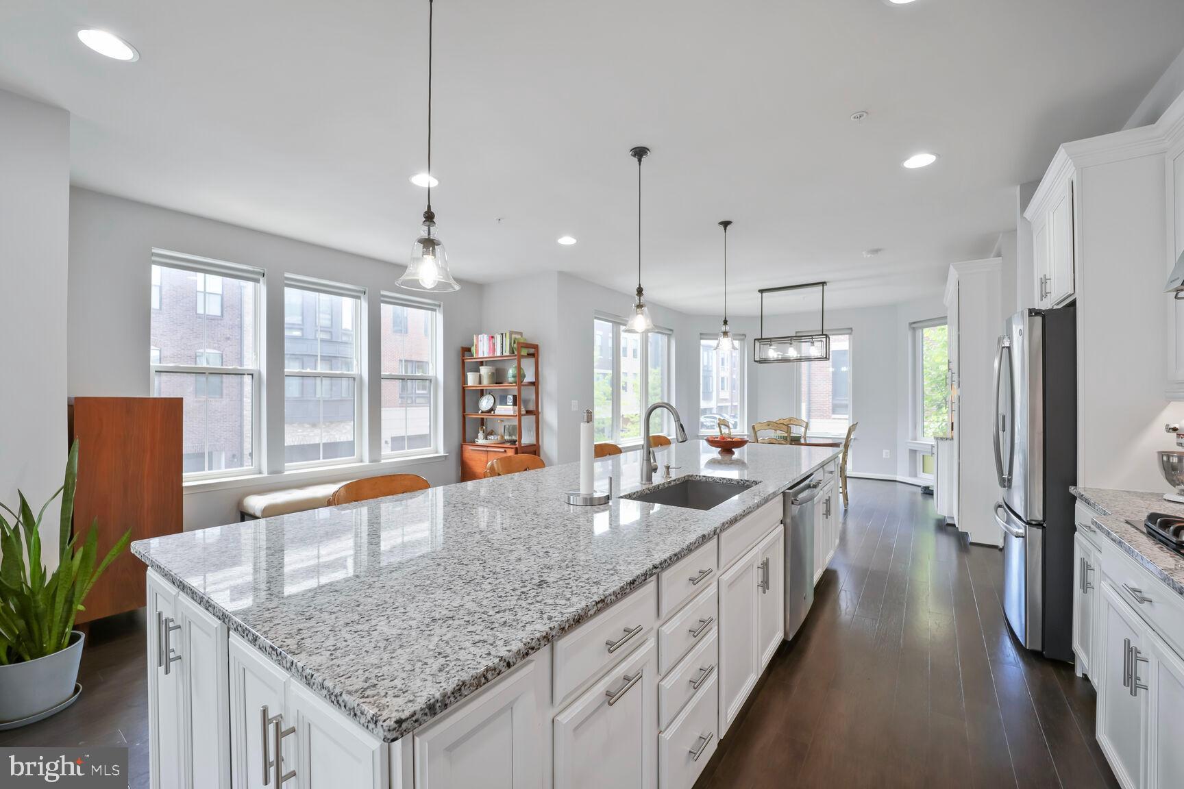 515 Riversail Lane, Unit 430 Oxon Hill, MD 20745 - Photo 16 of 54 a kitchen with stainless steel appliances granite countertop a sink a stove and a wooden floors