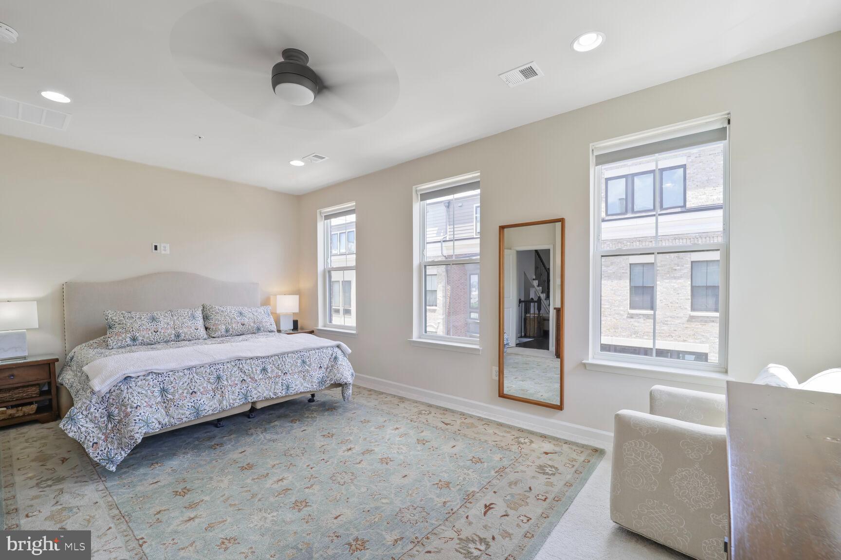 515 Riversail Lane, Unit 430 Oxon Hill, MD 20745 - Photo 18 of 54 a spacious bedroom with a large bed and windows