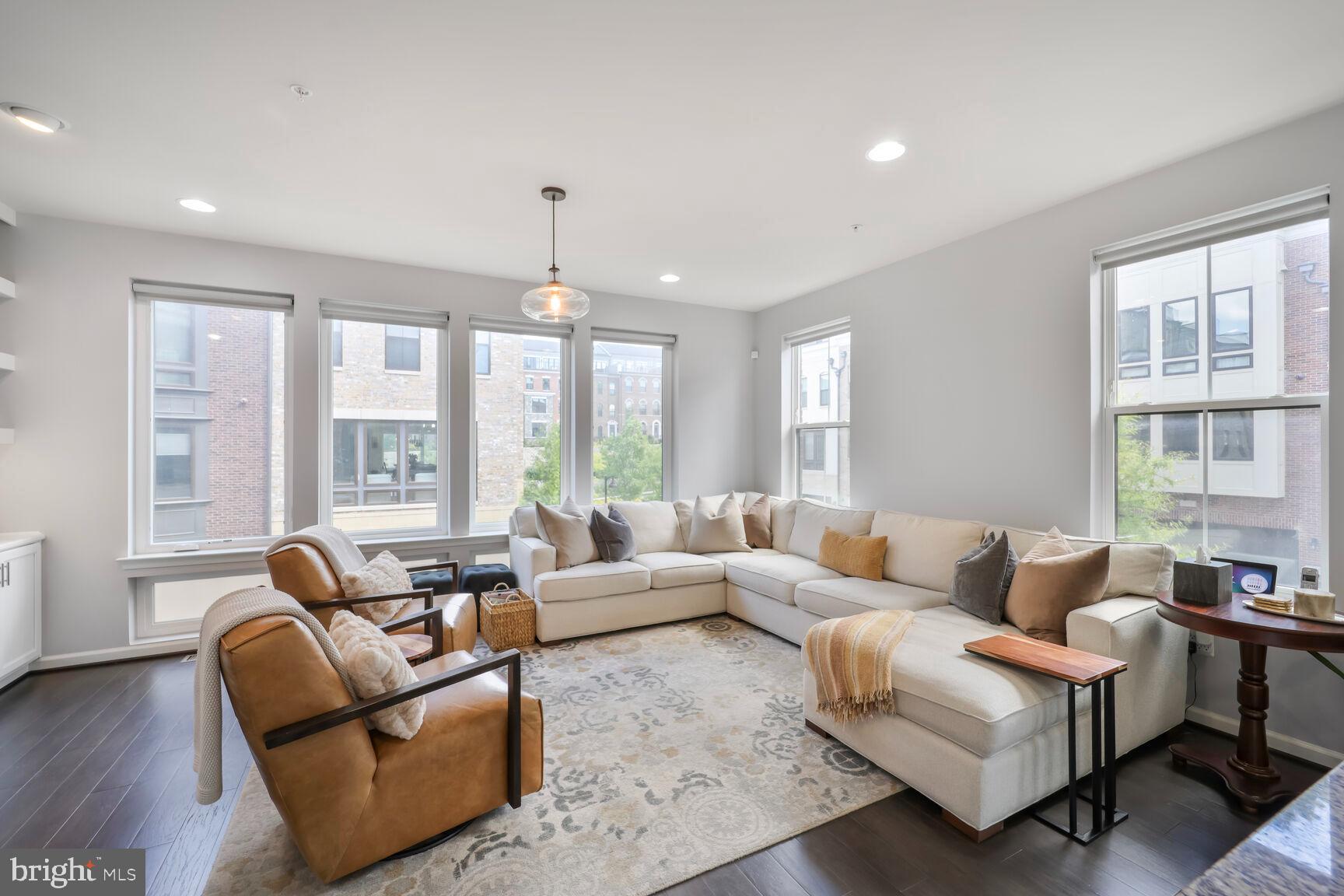 515 Riversail Lane, Unit 430 Oxon Hill, MD 20745 - Photo 2 of 54 a living room with furniture and large windows