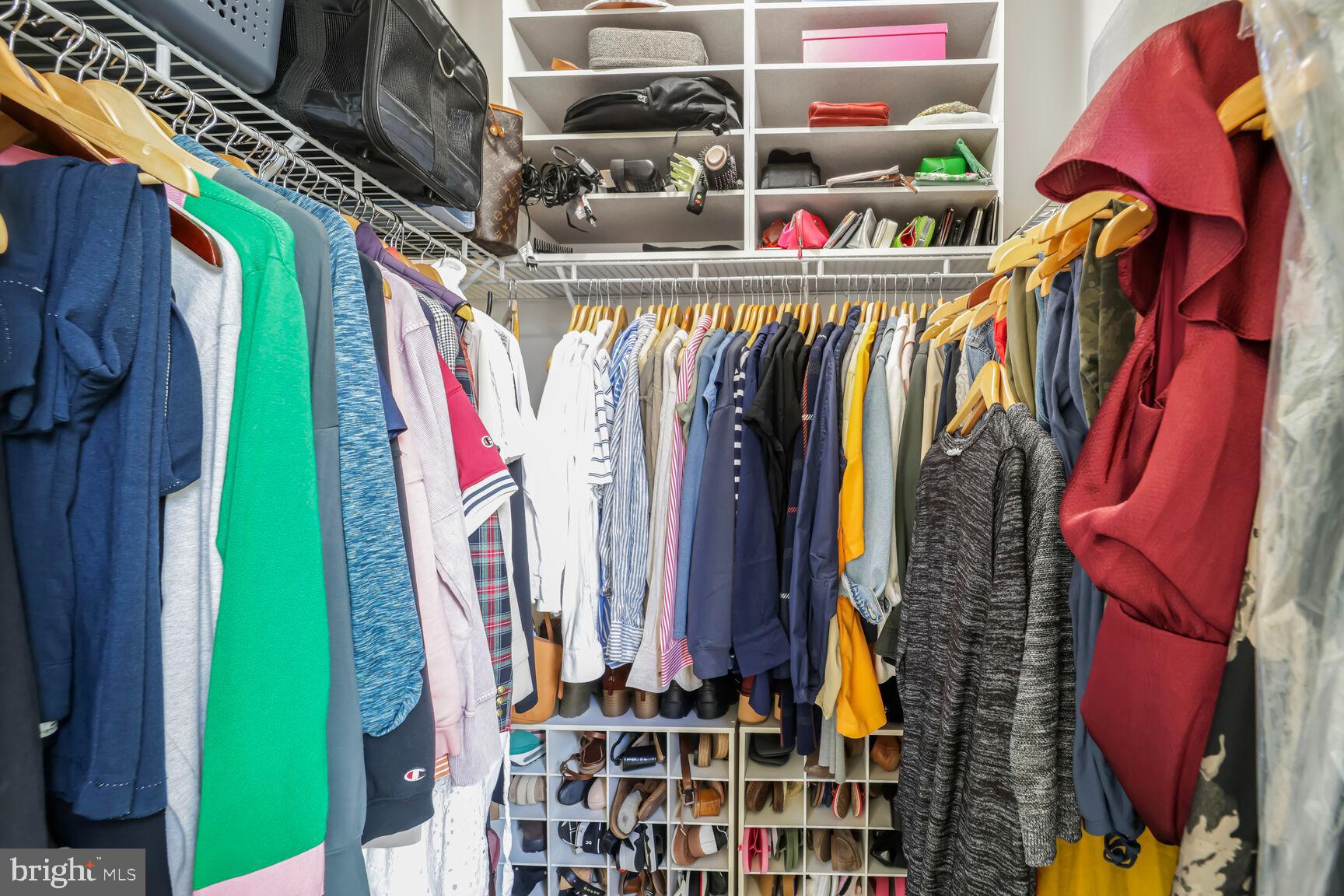 515 Riversail Lane, Unit 430 Oxon Hill, MD 20745 - Photo 23 of 54 a view of walk in closet with clothes and shoes