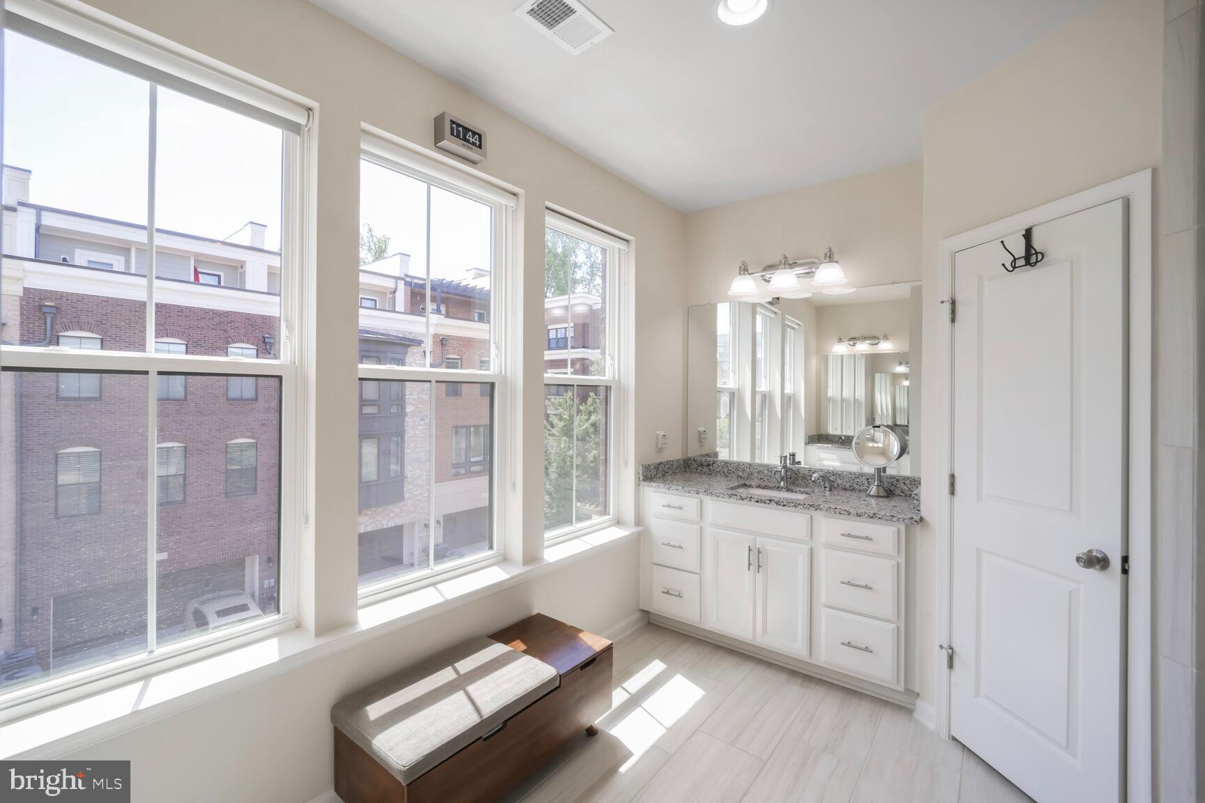 515 Riversail Lane, Unit 430 Oxon Hill, MD 20745 - Photo 24 of 54 a spacious bathroom with a granite countertop sink mirror and double