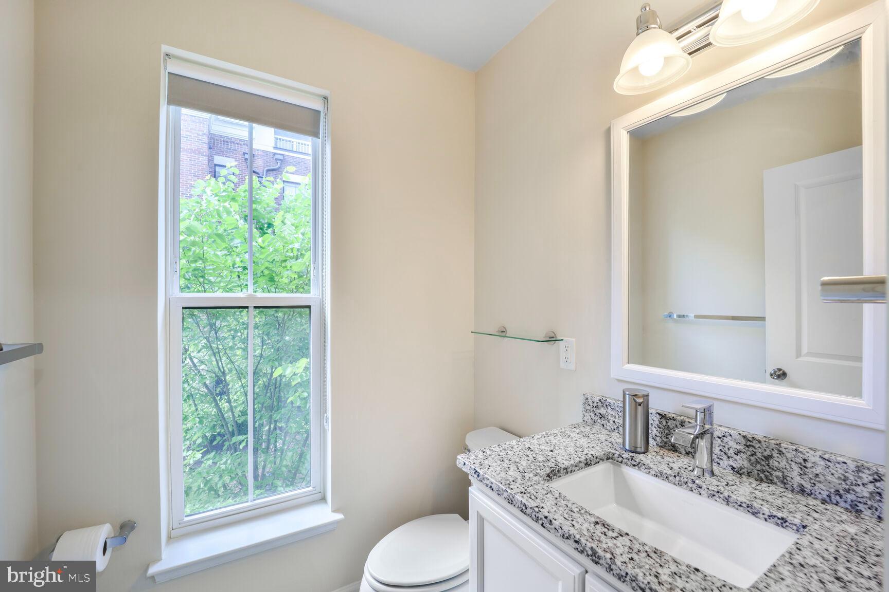 515 Riversail Lane, Unit 430 Oxon Hill, MD 20745 - Photo 25 of 54 a bathroom with a granite countertop sink toilet and mirror